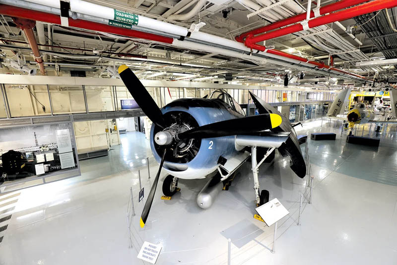 Interior view of the Intrepid Sea, Air & Space Museum showcasing a vintage military aircraft
