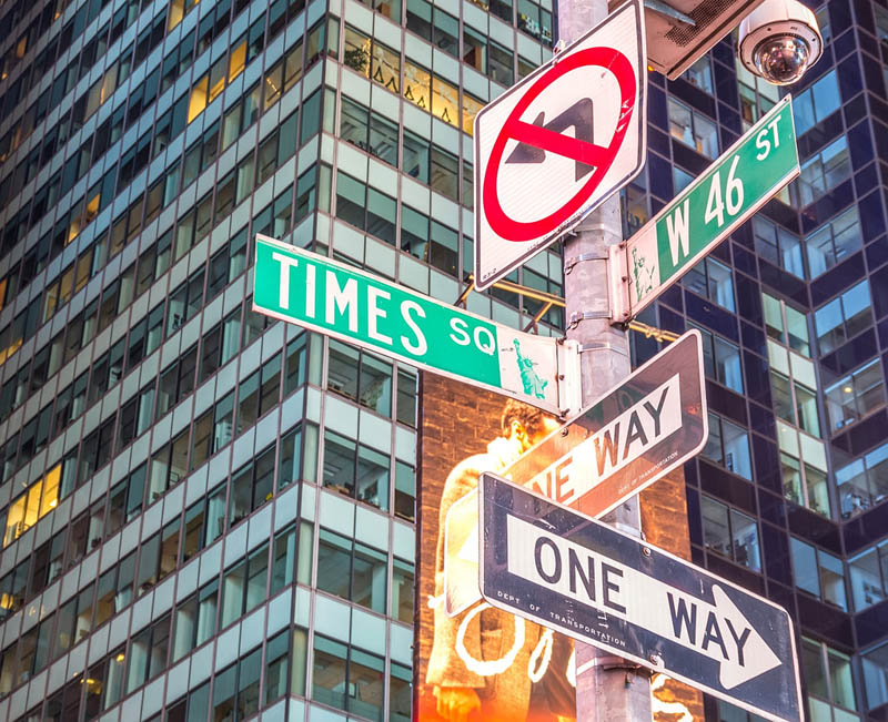 Street signs at the intersection of Times Square and West 46th Street in New York City