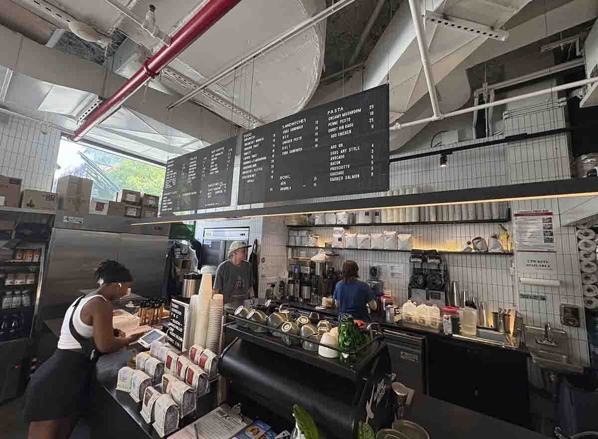 Inside White Noise Coffee in New York with baristas working behind the cafe counter